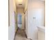 Upstairs hallway with a view into a bedroom, neutral walls, and white trim, connecting the upper-level spaces at 15846 Stable Run Dr, Spring Hill, FL 34610