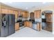 Bright kitchen features stainless steel appliances, granite countertops, and wood cabinets at 15846 Stable Run Dr, Spring Hill, FL 34610