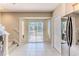 Bright breakfast nook featuring tile floors, sliding glass doors to a patio, and a modern refrigerator at 15846 Stable Run Dr, Spring Hill, FL 34610