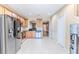 Spacious kitchen features stainless steel appliances, wooden cabinets, and tile flooring at 15846 Stable Run Dr, Spring Hill, FL 34610