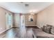 Spacious living room with hardwood floors and an open layout into adjacent rooms at 15846 Stable Run Dr, Spring Hill, FL 34610
