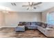 Spacious living room featuring sleek hardwood floors and a large comfortable sectional sofa at 15846 Stable Run Dr, Spring Hill, FL 34610