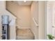 Carpeted staircase with white handrail and beige walls at 15846 Stable Run Dr, Spring Hill, FL 34610