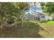 Landscaped backyard features a patio area with seating outside of the screened in pool at 18644 Autumn Lake Blvd, Hudson, FL 34667