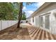 Spacious backyard with a brick patio, white fence, and direct access from the house at 18644 Autumn Lake Blvd, Hudson, FL 34667