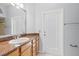 Bathroom with vanity, granite countertop, and door leading to the backyard at 18644 Autumn Lake Blvd, Hudson, FL 34667