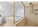 Luxurious bathroom featuring shower and soaking tub combination with glass block window at 18644 Autumn Lake Blvd, Hudson, FL 34667