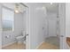 Bright bathroom featuring a toilet, bidet, and tiled floor, adjacent to a hallway at 18644 Autumn Lake Blvd, Hudson, FL 34667