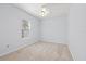 Clean bedroom with carpet, ceiling fan, and a large window at 18644 Autumn Lake Blvd, Hudson, FL 34667