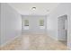 Well-lit, empty bedroom with tiled floors and two windows at 18644 Autumn Lake Blvd, Hudson, FL 34667