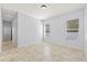 Bright bedroom with tiled floors, neutral walls, and two windows at 18644 Autumn Lake Blvd, Hudson, FL 34667