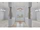 Elegant foyer with high ceilings, decorative tile flooring, and chandelier lighting at 18644 Autumn Lake Blvd, Hudson, FL 34667
