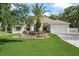 Well-maintained front yard featuring lush landscaping and a stunning water feature that enhance the curb appeal at 18644 Autumn Lake Blvd, Hudson, FL 34667