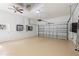 Spacious garage with painted floor, overhead door and door leading to outside at 18644 Autumn Lake Blvd, Hudson, FL 34667