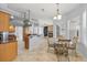 Open kitchen and dining area with stainless steel appliances and tile flooring at 18644 Autumn Lake Blvd, Hudson, FL 34667