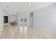 Bright and airy living room with tiled flooring, dining area, and view of the pool at 18644 Autumn Lake Blvd, Hudson, FL 34667