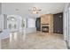 Open living room featuring a fireplace and travertine flooring at 18644 Autumn Lake Blvd, Hudson, FL 34667