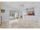 Open-concept living space with tile flooring, leading to a kitchen and sliding doors to the pool at 18644 Autumn Lake Blvd, Hudson, FL 34667