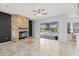 Bright living room featuring a stone fireplace and sliding glass doors to the pool area at 18644 Autumn Lake Blvd, Hudson, FL 34667