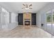Living room with stone fireplace and large sliding glass doors at 18644 Autumn Lake Blvd, Hudson, FL 34667