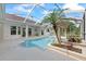 Tranquil pool area featuring a spa, mature landscaping, and a screened-in enclosure at 18644 Autumn Lake Blvd, Hudson, FL 34667