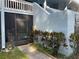 Building exterior showing unit entry with a screened-in porch and nicely landscaped sidewalk at 1983 Abrico Dr # H-9, Lutz, FL 33558