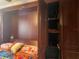 Murphy bed with decorative pillows and a built-in wardrobe providing storage space at 1983 Abrico Dr # H-9, Lutz, FL 33558