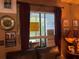 Interior window view with dark curtain, window AC and framed decoration at 1983 Abrico Dr # H-9, Lutz, FL 33558