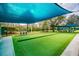 A well-manicured bocce ball court with seating, providing a recreational space for residents at 20720 Eustis Rd, Land O Lakes, FL 34637