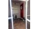 Charming front porch with a bright red door, decorated with a floral wreath and 'Gather' sign at 20720 Eustis Rd, Land O Lakes, FL 34637
