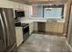 Bright kitchen featuring white cabinets, modern stainless steel appliances, and neutral countertops at 20720 Eustis Rd, Land O Lakes, FL 34637