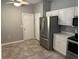 Well-lit kitchen features stainless steel appliances, white cabinets, and tile flooring, offering ample storage at 20720 Eustis Rd, Land O Lakes, FL 34637