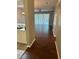 Open-concept living room featuring wood floors and ample natural light coming from the window with white blinds at 20720 Eustis Rd, Land O Lakes, FL 34637