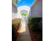 Gated walkway leading to a property, lined with lush landscaping and mulch ground cover at 20720 Eustis Rd, Land O Lakes, FL 34637