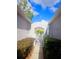 Gated walkway leading to a property, lined with lush landscaping and mulch ground cover at 20720 Eustis Rd, Land O Lakes, FL 34637