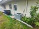A view of the home's backyard, showcasing the AC unit and door to the home at 2083 Envoy Ct, Clearwater, FL 33764