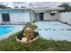 This backyard features a pool, patio, and rock fountain at 2083 Envoy Ct, Clearwater, FL 33764