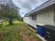 A view of the home's backyard, which features the home's exterior, and foliage at 2083 Envoy Ct, Clearwater, FL 33764