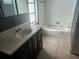 The bathroom includes a single vanity, bath tub, and tiled floors at 2083 Envoy Ct, Clearwater, FL 33764