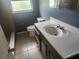 Bathroom featuring vanity, mirror and toilet at 2083 Envoy Ct, Clearwater, FL 33764