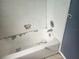 This outdated bathtub features white tiling and older fixtures at 2083 Envoy Ct, Clearwater, FL 33764