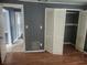 This bedroom features wood floors, a closet, and several doorways to other rooms in the home at 2083 Envoy Ct, Clearwater, FL 33764