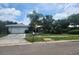 Charming single-story home with a well-maintained front yard and mature landscaping at 2083 Envoy Ct, Clearwater, FL 33764