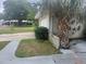 Property featuring a palm tree near the garage and front yard landscaping at 2083 Envoy Ct, Clearwater, FL 33764
