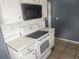 Kitchen features white appliances and cabinetry at 2083 Envoy Ct, Clearwater, FL 33764