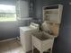 A laundry room with a sink and washer at 2083 Envoy Ct, Clearwater, FL 33764