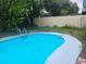 Backyard pool with ladder and view of the surrounding fence at 2083 Envoy Ct, Clearwater, FL 33764