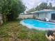 Backyard pool with slide, ladder, and view of the home's exterior at 2083 Envoy Ct, Clearwater, FL 33764