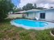 Backyard pool with slide, ladder, and view of the home's exterior at 2083 Envoy Ct, Clearwater, FL 33764