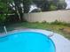 Backyard pool with ladder and view of the surrounding fence at 2083 Envoy Ct, Clearwater, FL 33764